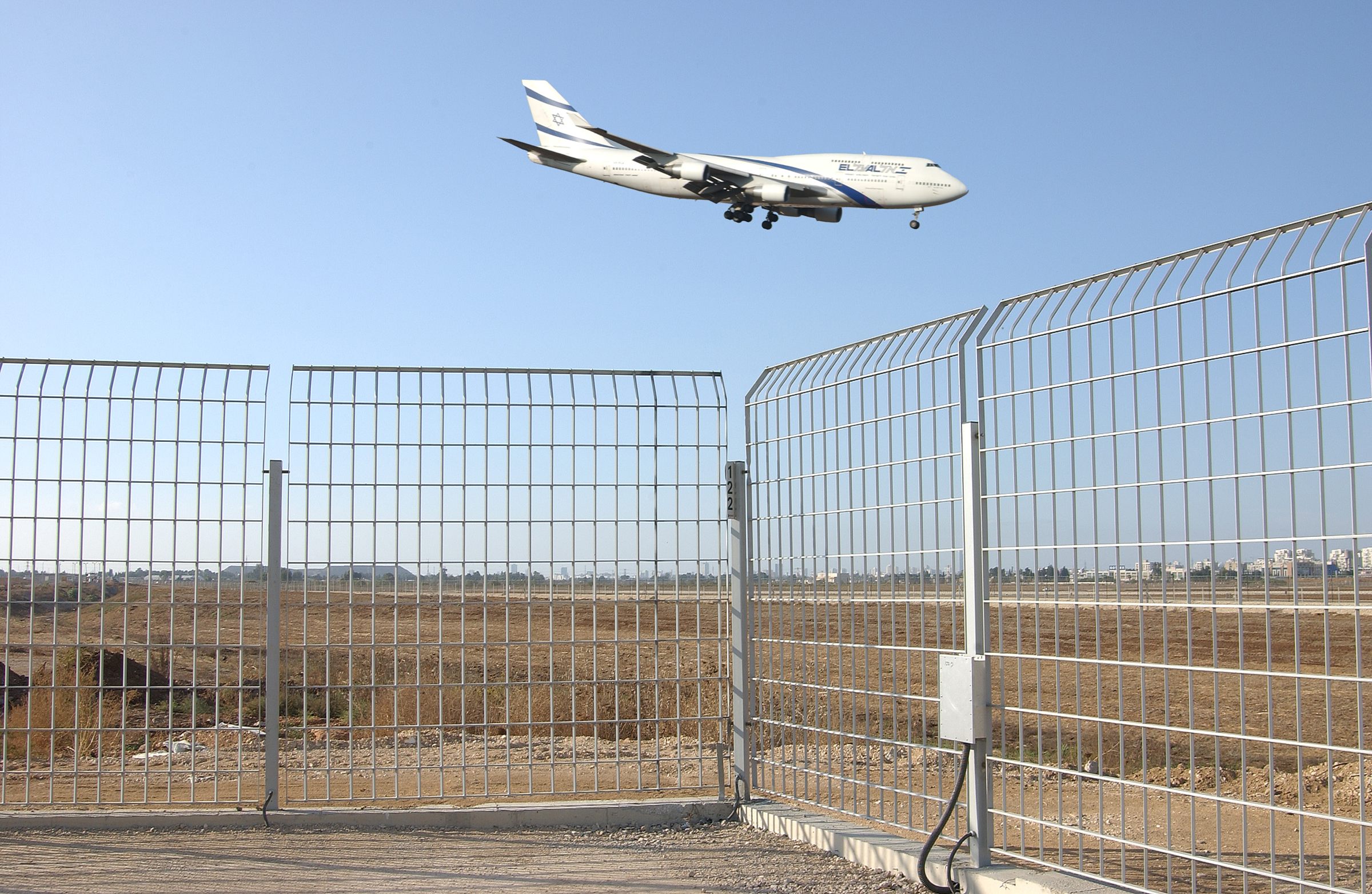 An El Al Boeing 747 lands low over the D-Corative sensor fence on the perimeter of Ben Gurion International Airport