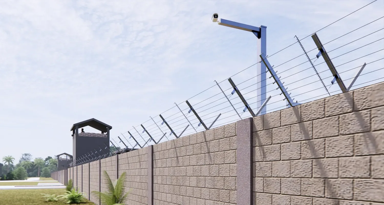 A border wall with a D-FENCE taut-wire sensor line along its top and a watchtower behind it