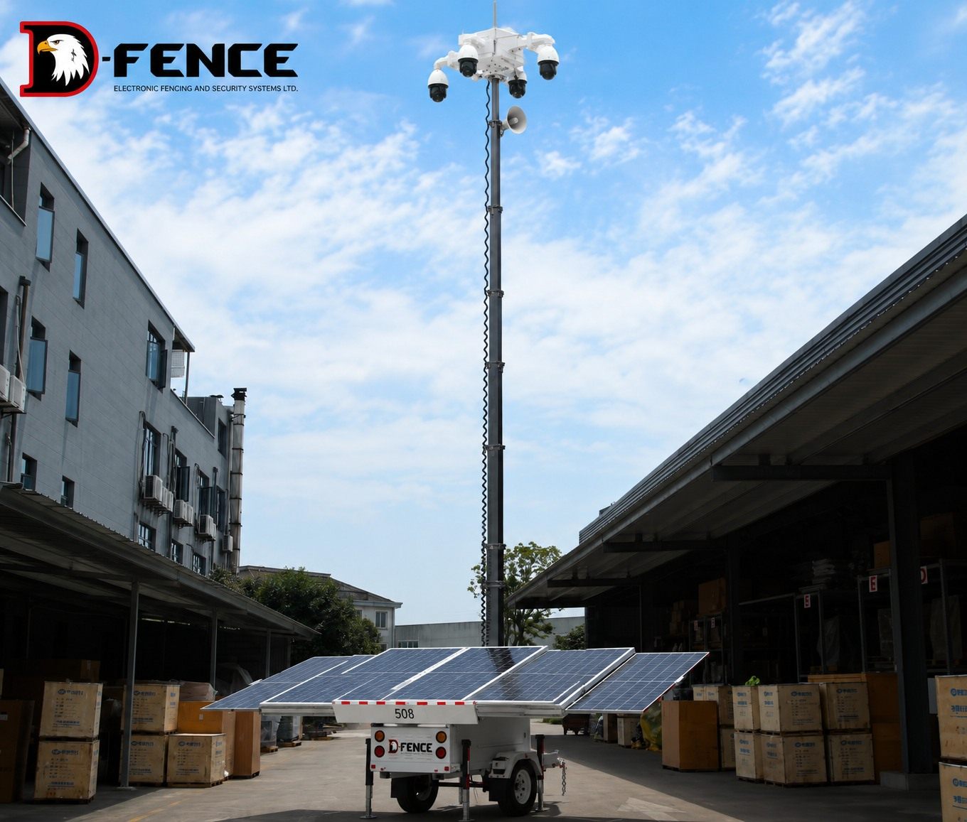White D-FENCE solar trailer with four PTZ dome cameras and a loudspeaker on a fully raised mast in a warehouse yard