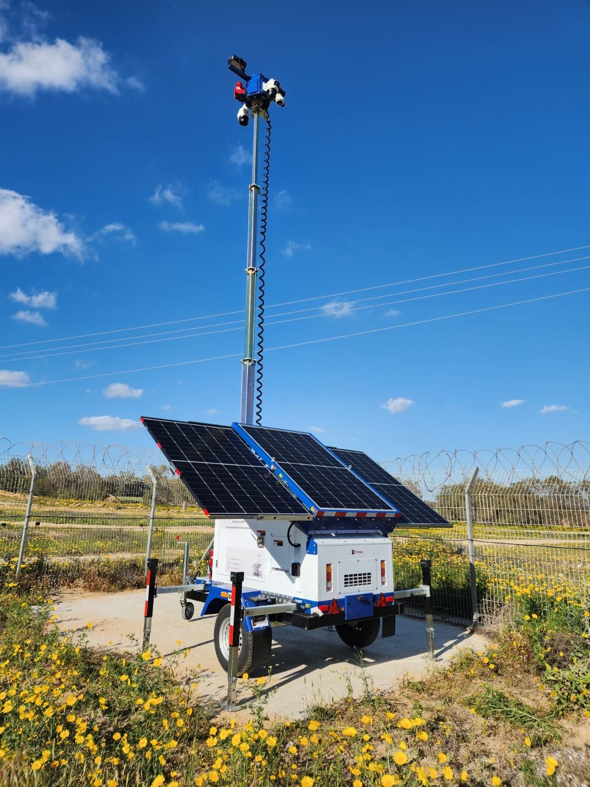 AI-EYE IN THE SKY solar trailer with its camera mast raised in a field