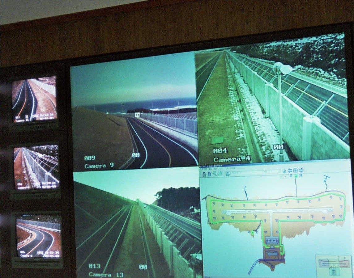 Airport control-room video wall: fence cameras beside a perimeter alarm map of the airfield