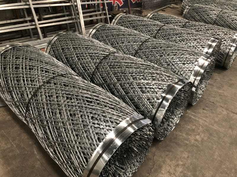 Rolls of razor mesh stacked on a factory floor
