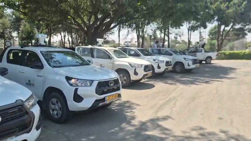 Row of white pickup trucks of a regional-council security unit, each carrying a NOA day/thermal head on its roof