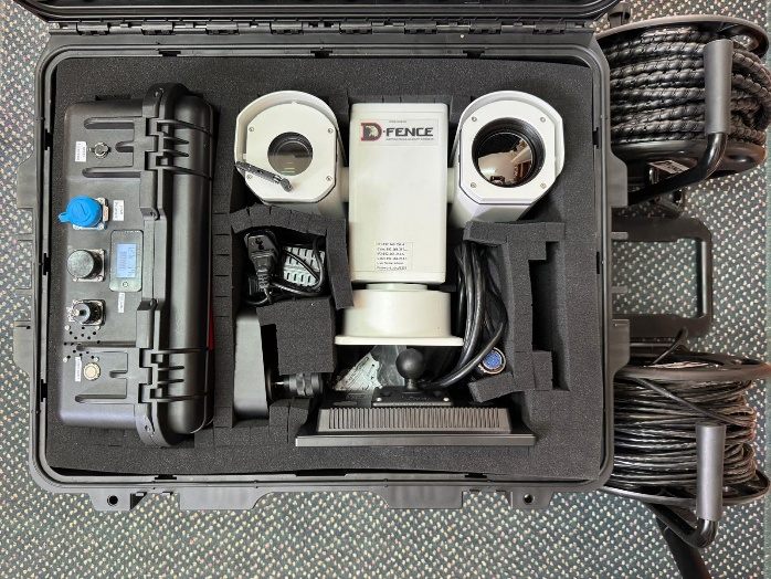 NOA kit laid out in an open rugged case: PTZ head, control and energy box, cables